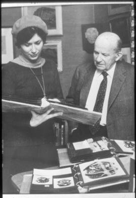 Madeline Bronsdon Rowan and Walter C. Koerner looking at prints.