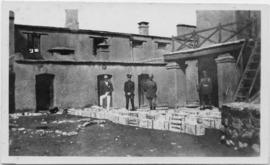 Military officers standing in front of crates