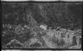 Ruins of stone buildings on a mountainside