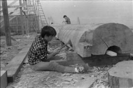 Crew working on log at the Turnbull & Gail construction yard in Richmond (contractors for bui...