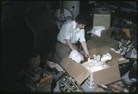 A museum staff member or student unpacks items for display in the new Museum of Anthropology.