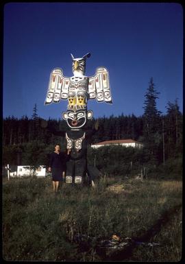 Woman next to thunderbird totem pole