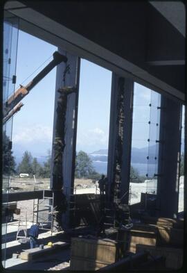A totem pole being positioned in the Museum of Anthropology