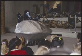 Children watch a performance by Garbanzo