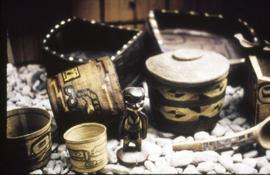 Baskets, bentwood dishes, a figure, and a spoon on display in Montréal