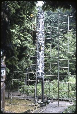 Scaffolding surrounds a totem pole