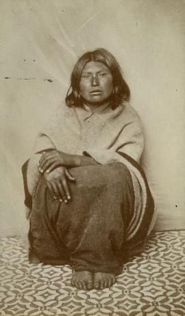 [Portrait of woman seated on tile floor]