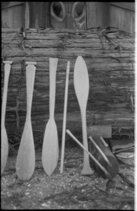 Paddles set against log