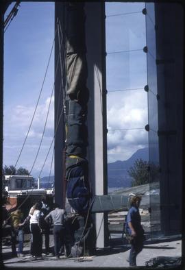 A totem pole being secured in the new Museum of Anthropology