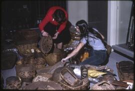 Inge Ruus with a museum staff member or student unpacking baskets for display in the new Museum o...