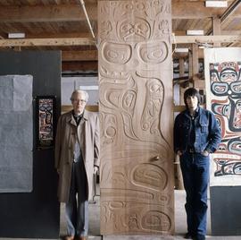 [Bill Reid next to artwork]