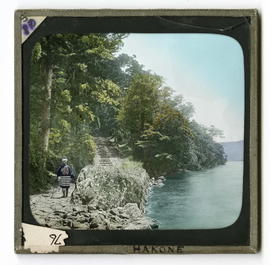 Man standing beside stone stairs along river
