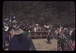 Masked dancer and crowd, Alert Bay