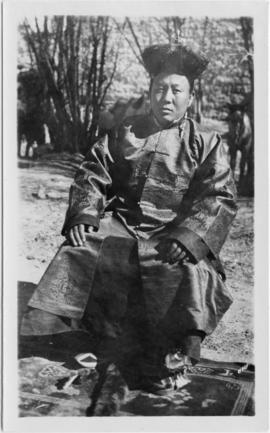 Tibetian man seated outdoors; identified in notes as "Shasw Khusho." Woman in a033681 i...