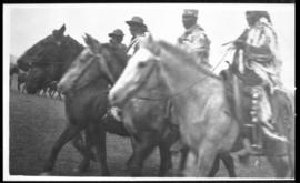View of four men on horseback