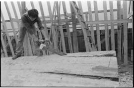 Crew working on log at the Turnbull & Gail construction yard in Richmond (contractors for bui...