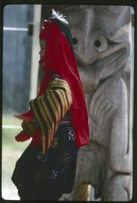 Japanese dancer in front of totem pole