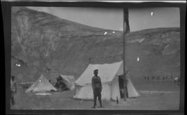 Tibetan soldier standing in front of an army tent