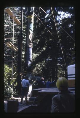 A totem pole being prepared to be lifted