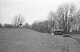 [Crane drags drunnage to top of hill]