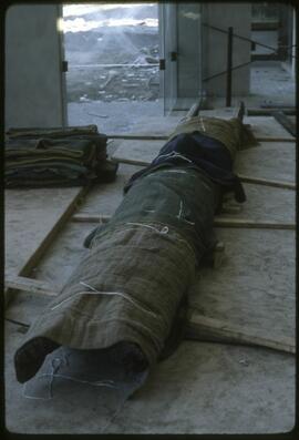 A totem pole lying on the floor of the Museum of Anthropology
