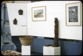 Small totem pole, basket, prints, and other objects