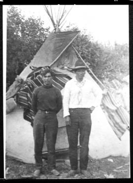 Portrait of two men in front of tipi