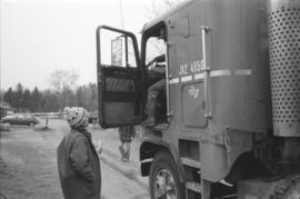 [Reva speaking with truck driver]