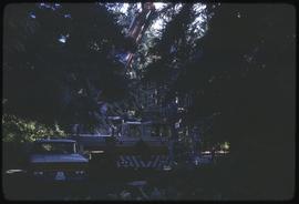 A crane preparing to lift a totem pole