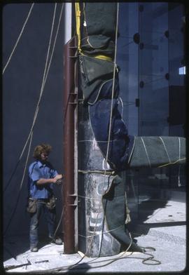 A totem pole being secured in the new Museum of Anthropology