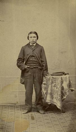 Portrait of man posed with table with a floral tablecloth