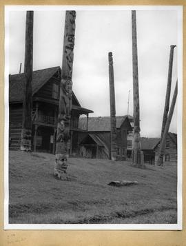 Totem poles in front of buildings