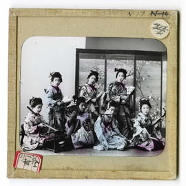 Group of young women (Geisha?) with musical instruments and fans