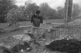 [Ron uses maul to shape log]