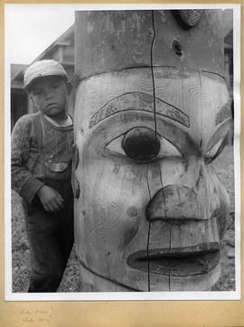 Child and totem pole, view two