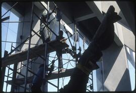 Workers raising a totem pole in the Museum of Anthropology