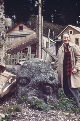 Helen Codere '56 [next to old stone carving]