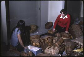 Inge Ruus with a museum staff member or student unpacking baskets for display in the new Museum o...