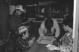 [Norman begins drawings for canoe log as Chip, Isaac and Ron watch]