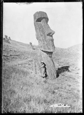 Young girl in front of a moai