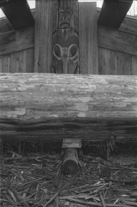 [Middle portion of log in front of long house]