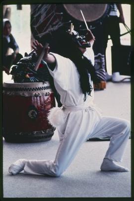 Masked performer and drums